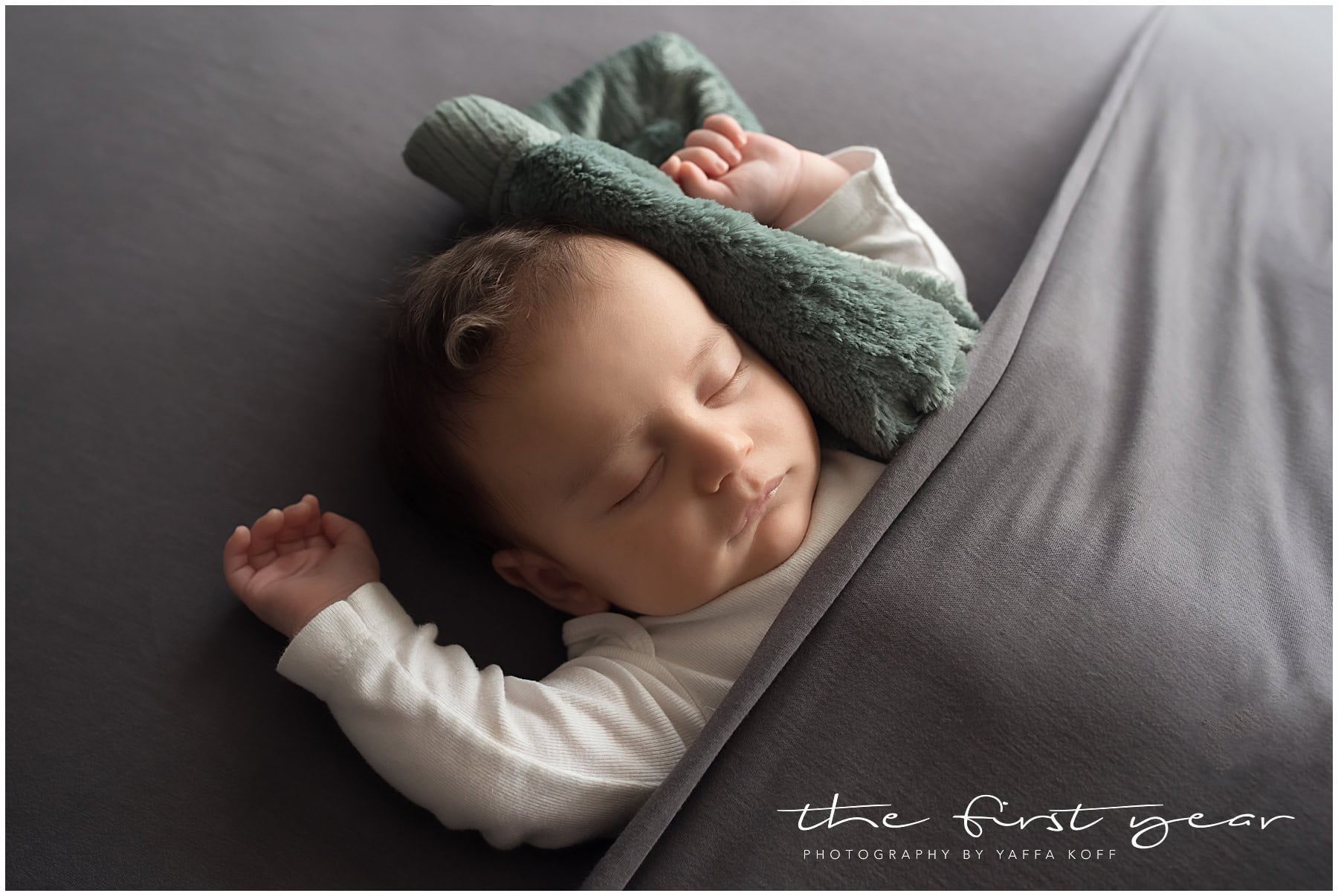 Adorable newborn sleeping peacefully with a soft Saranoni blanket in Silver Spring, MD.