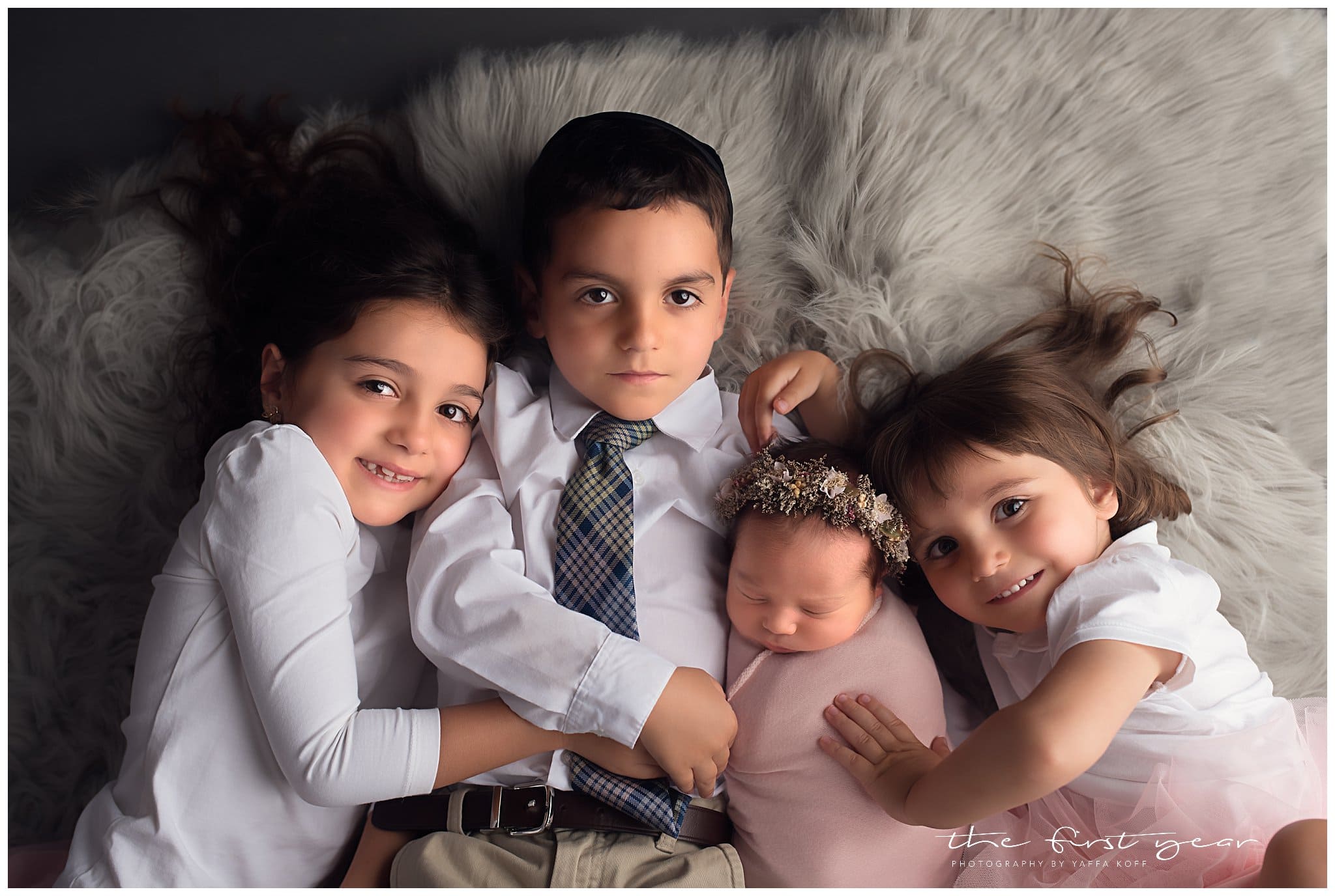 Adorable siblings with newborn baby girl, captured during a Chevy Chase, MD newborn photography sess.
