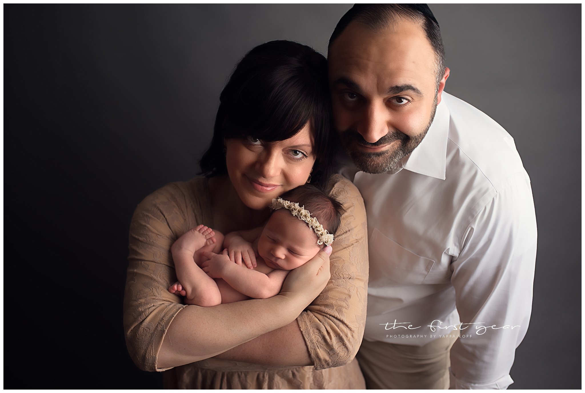 Adorable newborn girl with parents in a studio photo session in Chevy Chase, MD.