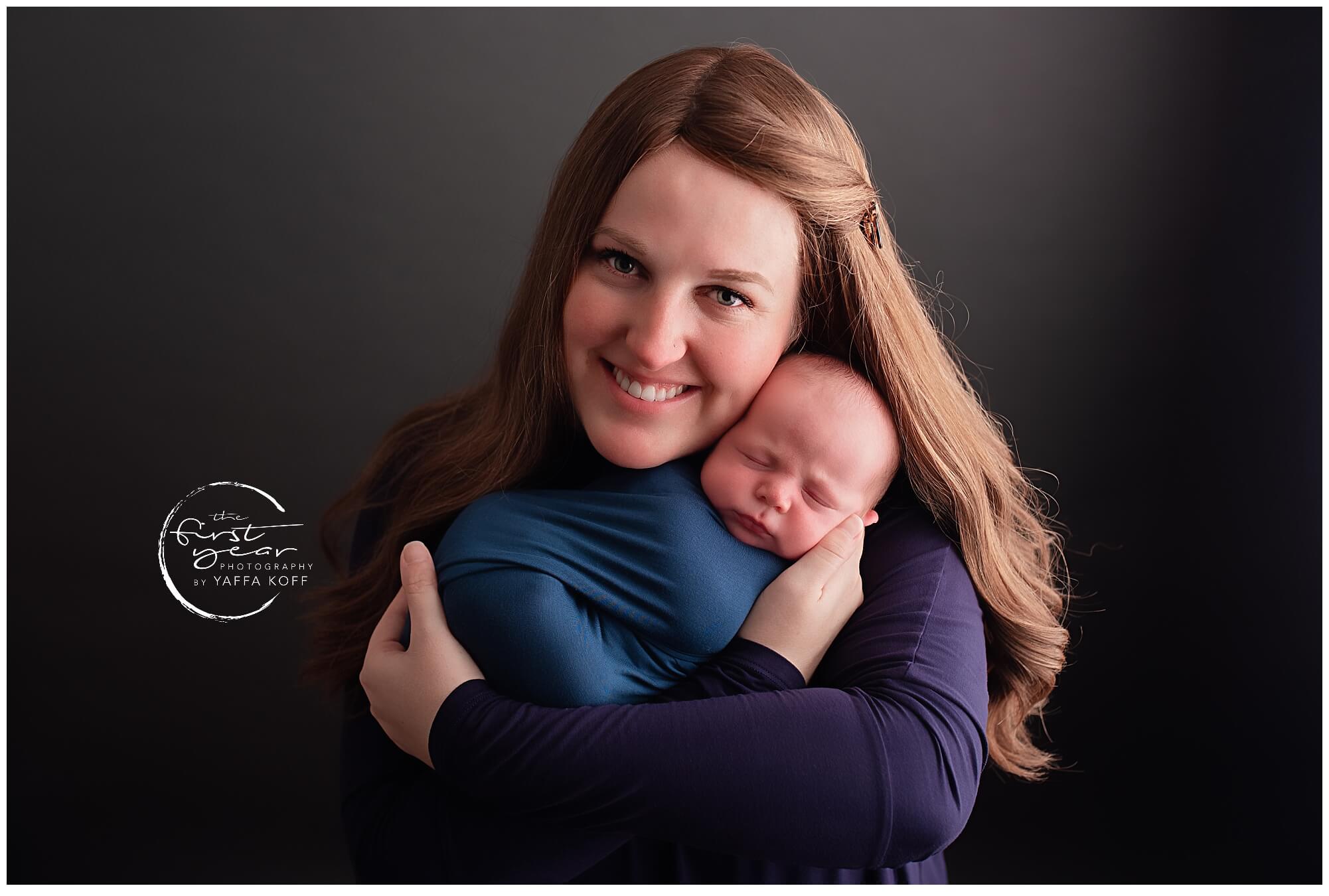 Adorable newborn Yehuda cuddled by mother in a professional Maryland photoshoot.