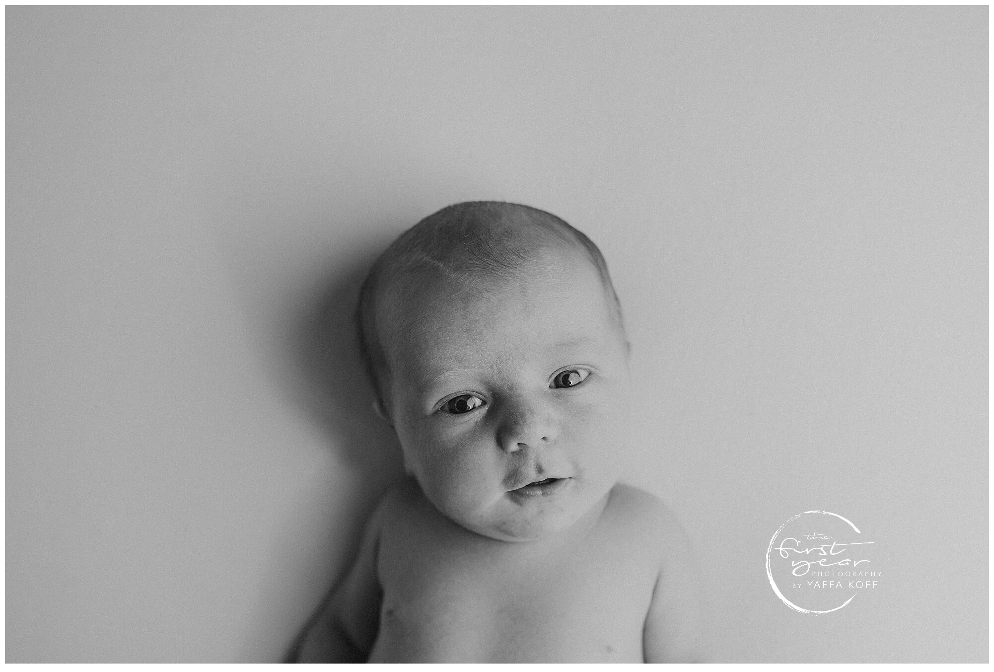 Newborn baby Yehuda lying peacefully, captured during Maryland newborn photography session.