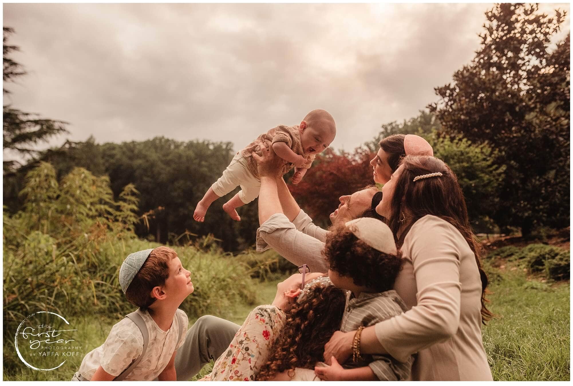 Family outdoor portrait in Silver Spring, MD with parents and children enjoying a sunny day.