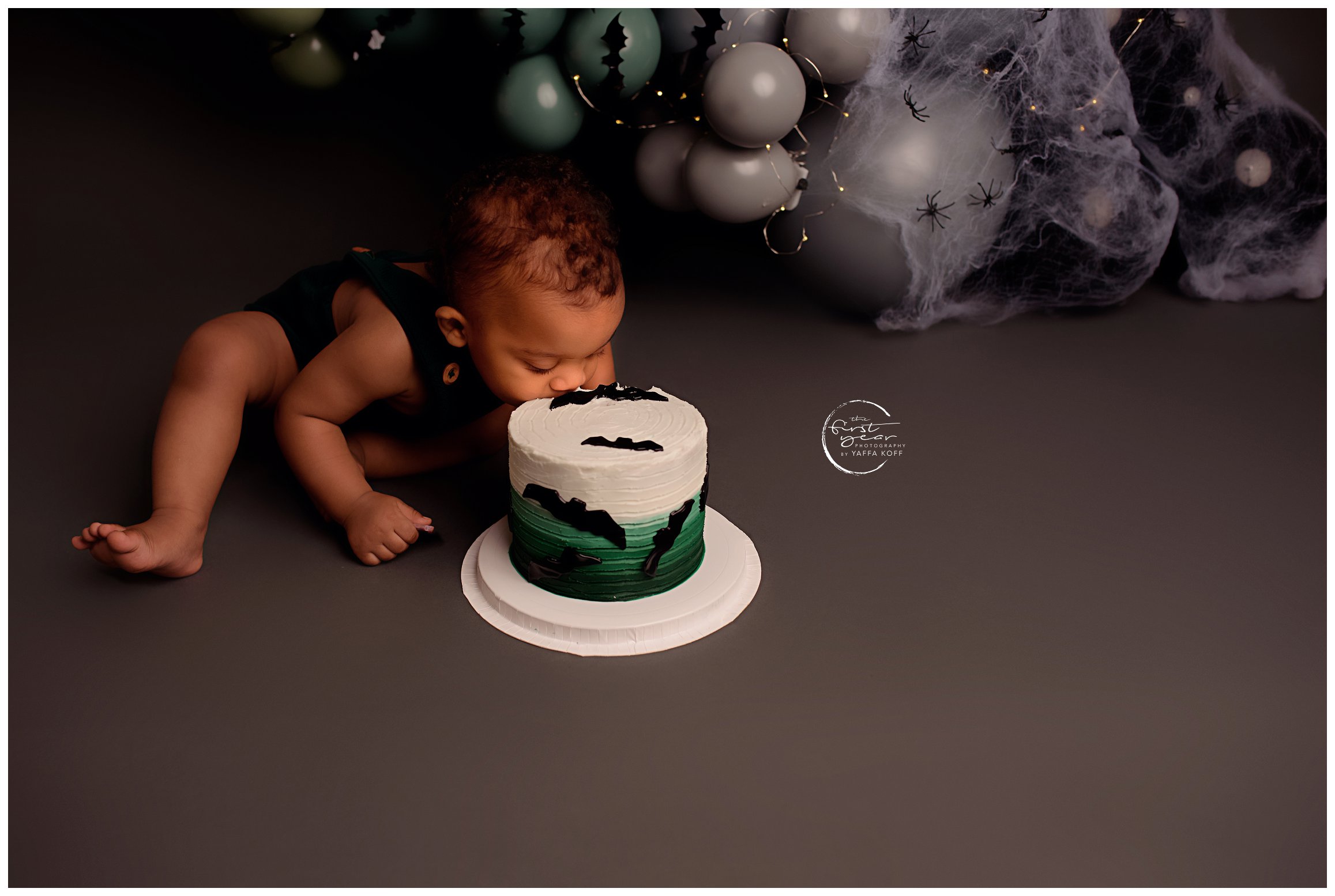 Young baby takes a bite from a cake for Silver Spring Newborn Photographer