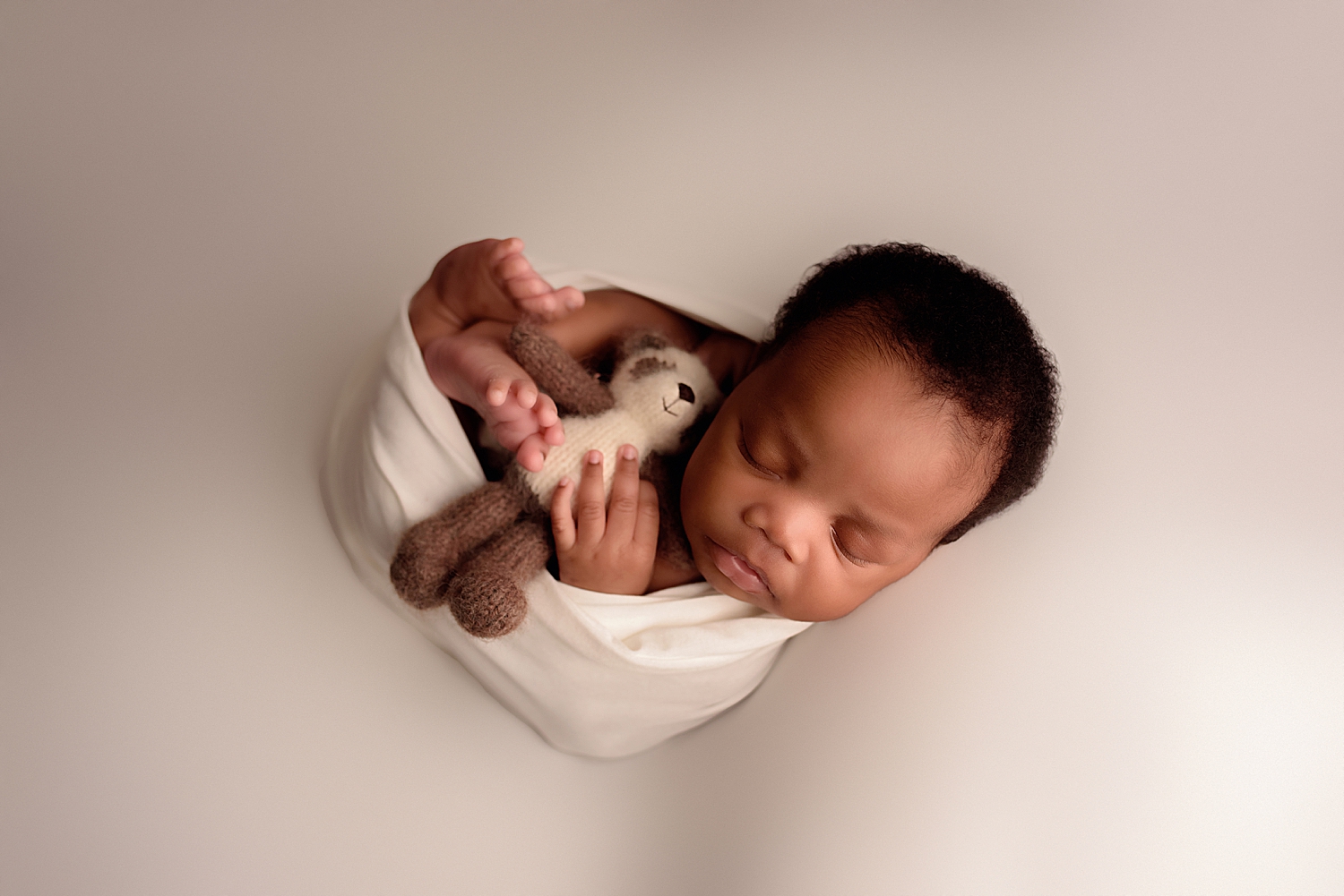 baby snuggles in a white Fine Art warp by Yaffa Koff Photography 
