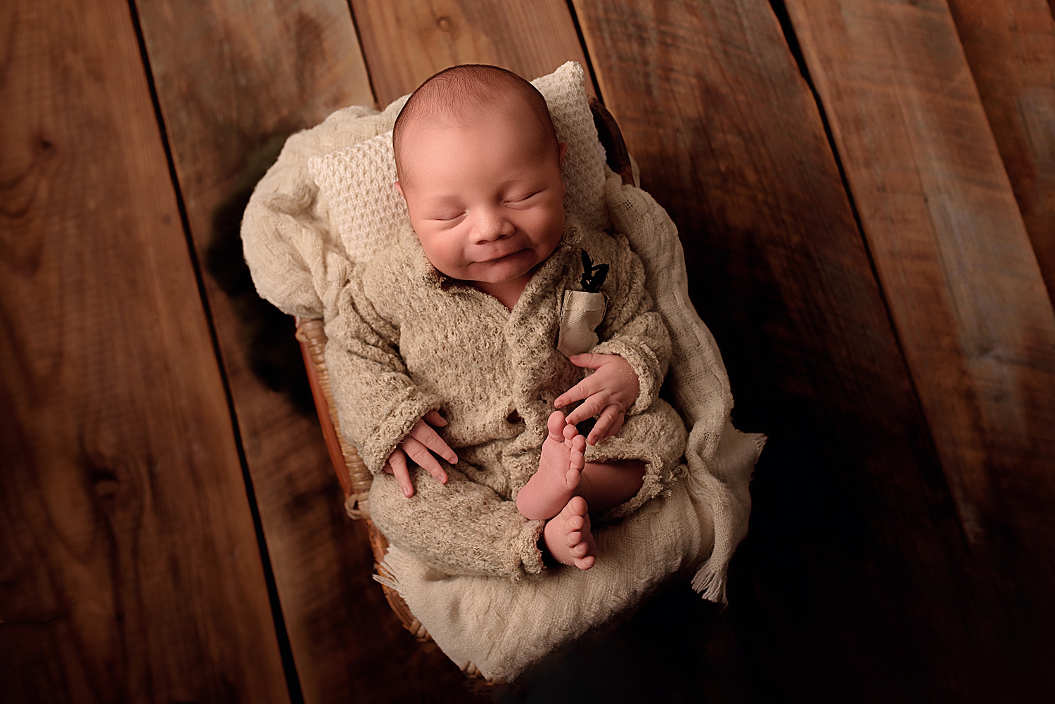 little one in textured beige onesie while learning how to get baby to smile