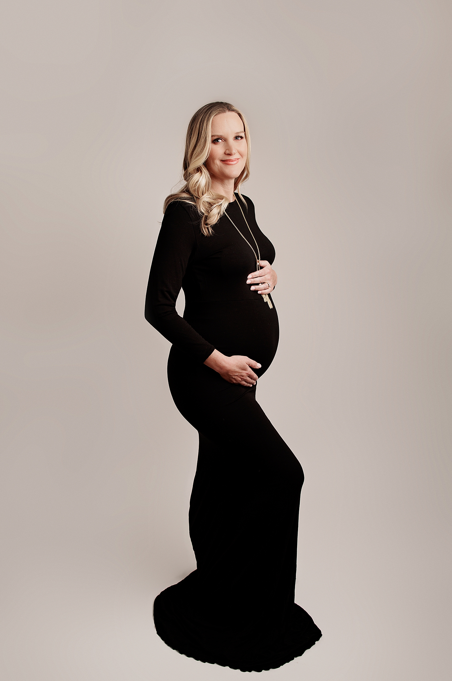 mama stands in long black dress with necklace by Yaffa Koff Photography