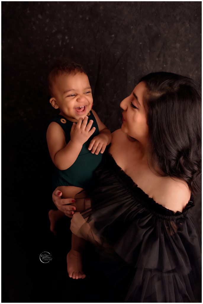 Happy baby with mom during cake smash in Silver Spring, MD.