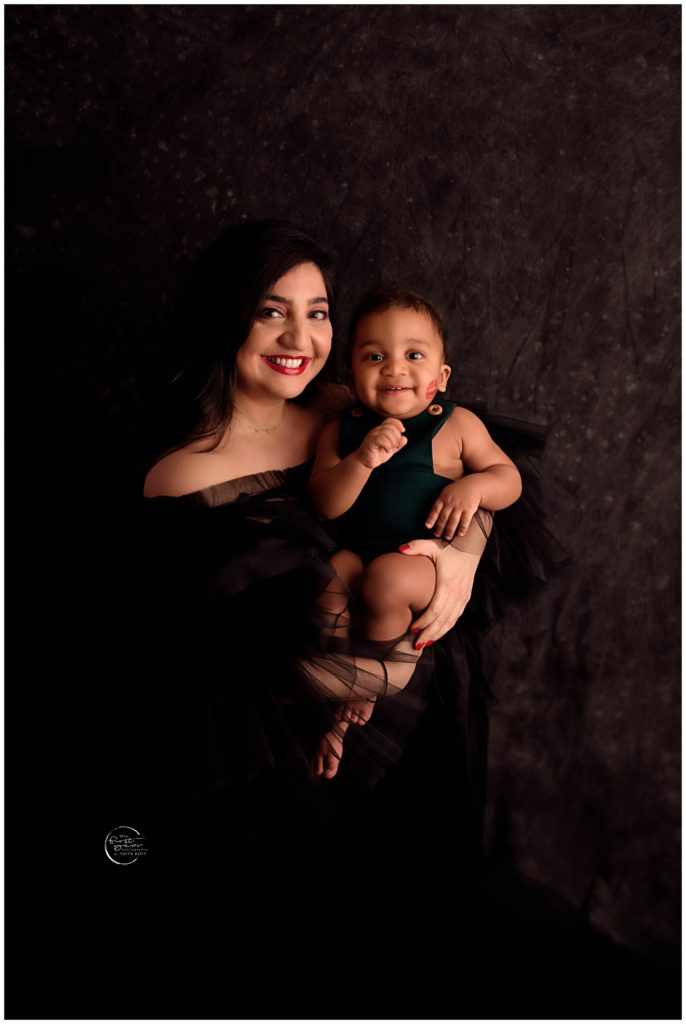 Happy mother and baby girl during cake smash session in Silver Spring, MD.