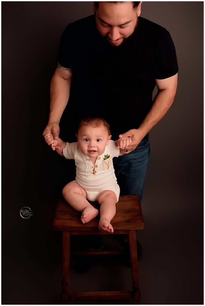 First Birthday Photos of a baby with father in a studio setting.