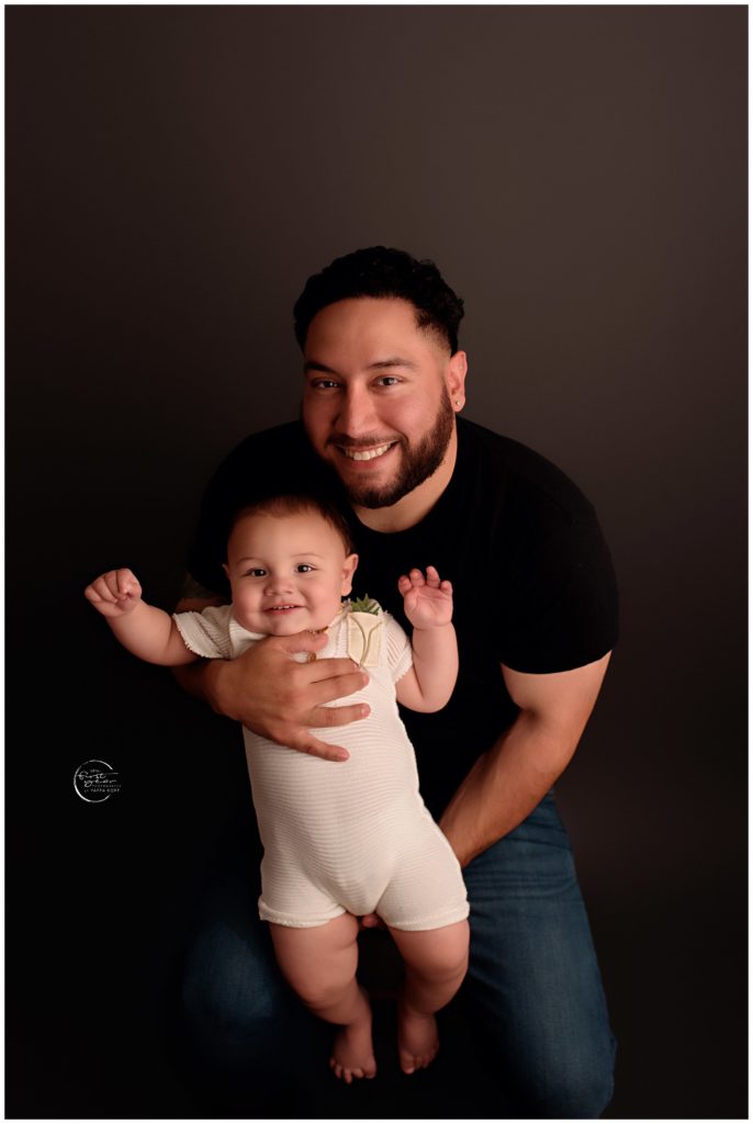 Happy baby with father during first birthday photoshoot in Silver Spring, MD.